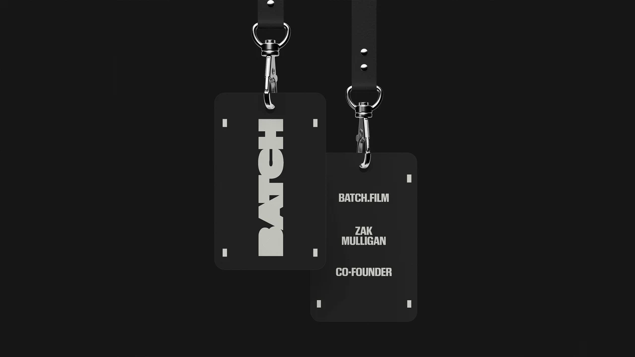Two black badges hanging from straps show a vertical BATCH wordmark, white name and role text, and small framing marks.