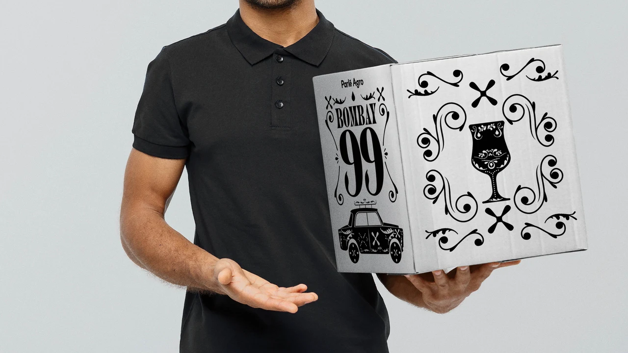 Person in a black polo presents a white Bombay 99 box with the brand name, a goblet illustration and black ornamental borders.