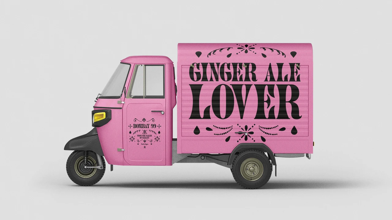 Three-wheeled vehicle is wrapped in pink with black Ginger Ale Lover lettering, a Bombay 99 logo and small ornamental motifs.