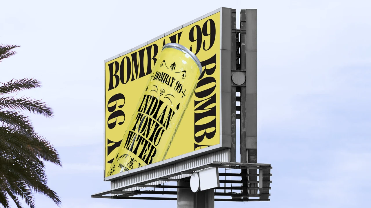 Elevated yellow billboard shows an angled Indian Tonic Water can and oversized repeated Bombay 99 lettering, with a palm tree beside it.