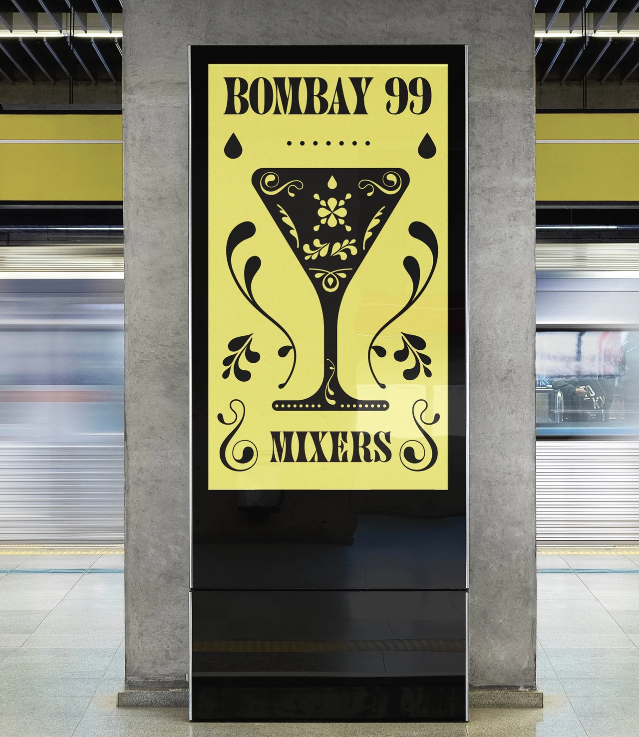 Yellow station poster displays Bombay 99 and Mixers around a large black ornamental goblet, with a blurred train behind.