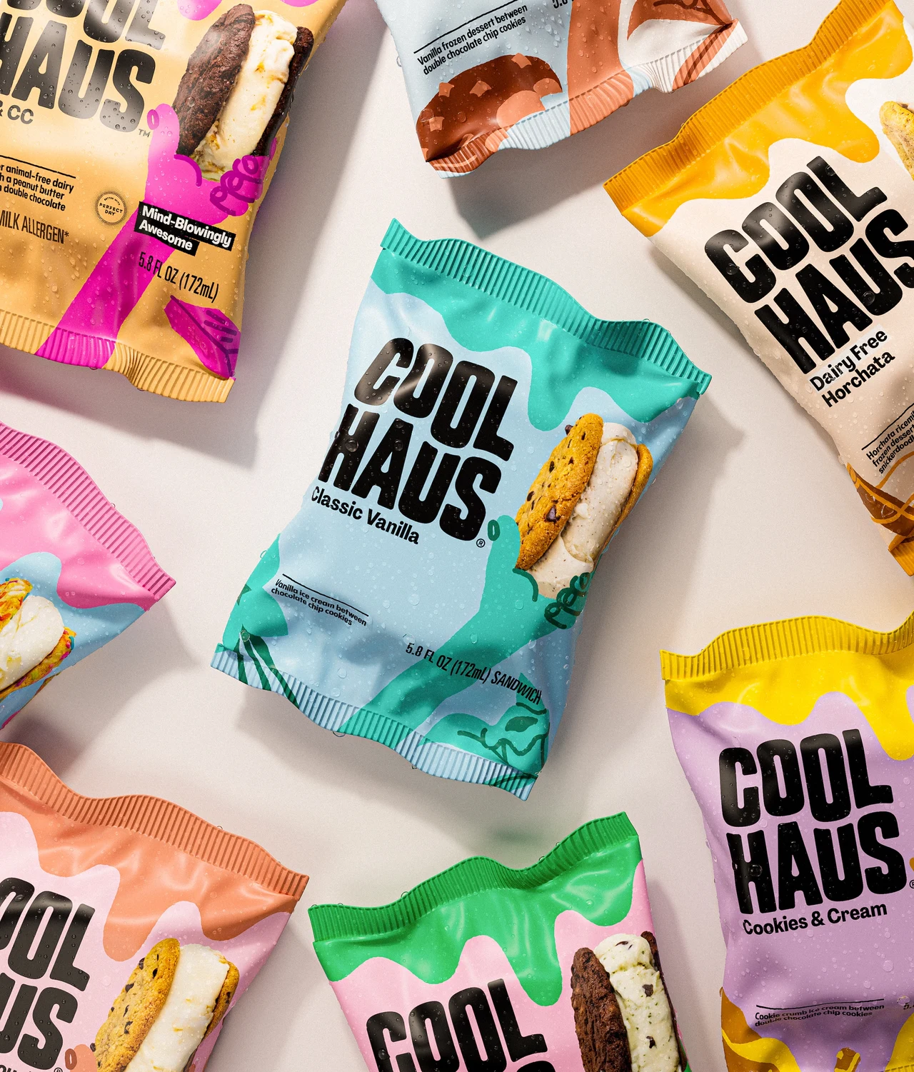 Individual ice cream sandwich wrappers are spread on a pale background, combining blue, pink, yellow and green with the Coolhaus wordmark and product images.