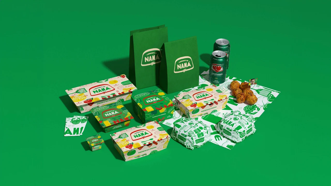 Lanchonete do Naná packaging, green bags, sandwiches, savory snacks and Guaraná Antarctica cans arranged on green.
