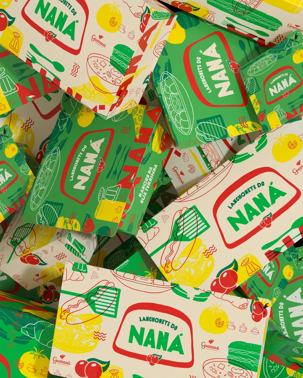 Naná boxes and packages overlap in a food-illustration pattern in green, red and yellow on cream.