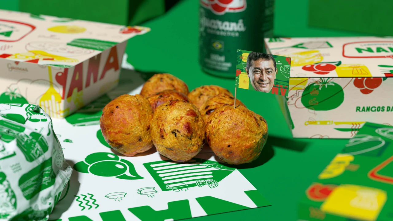 Close-up of golden savory snacks on illustrated paper, with a wrapped sandwich, Naná boxes and a green can behind them.