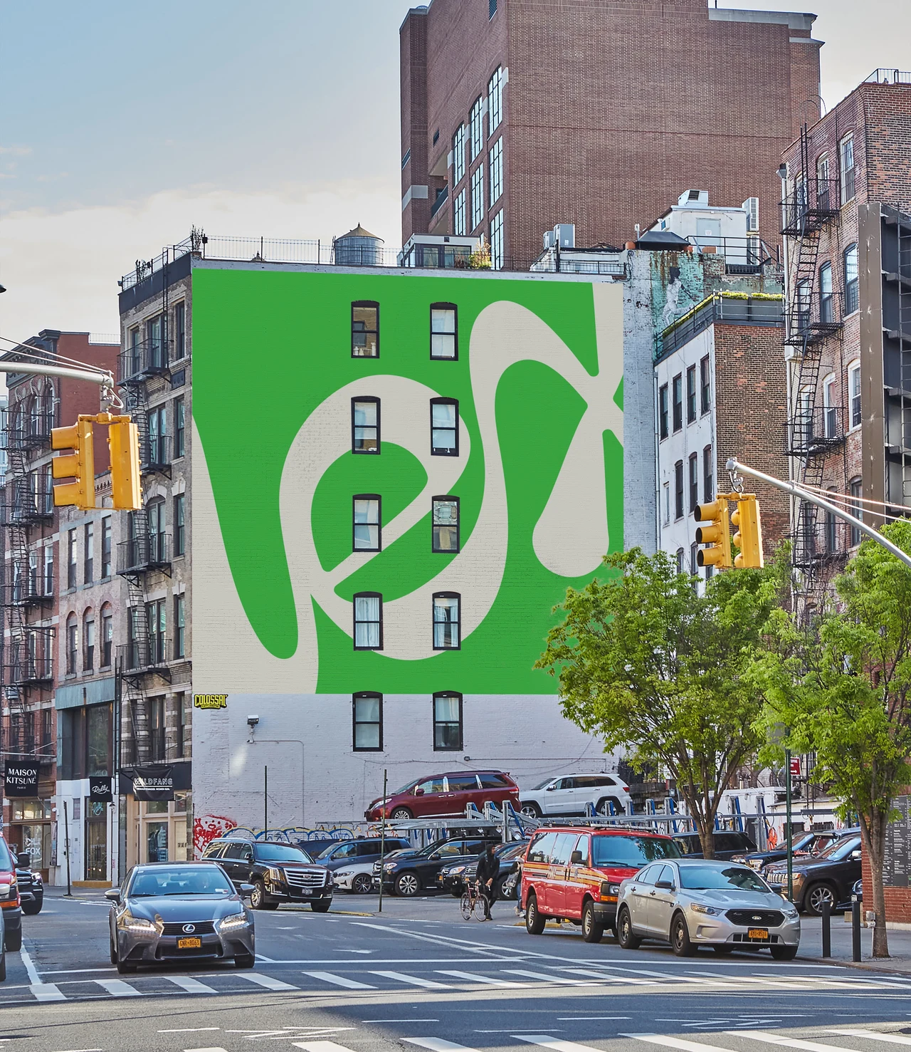 A building side wall carries a green mural with the cream Lex wordmark above a city intersection.