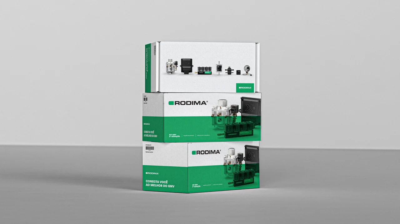 Stacked white and green Rodima boxes display automotive component photographs, information and logos.