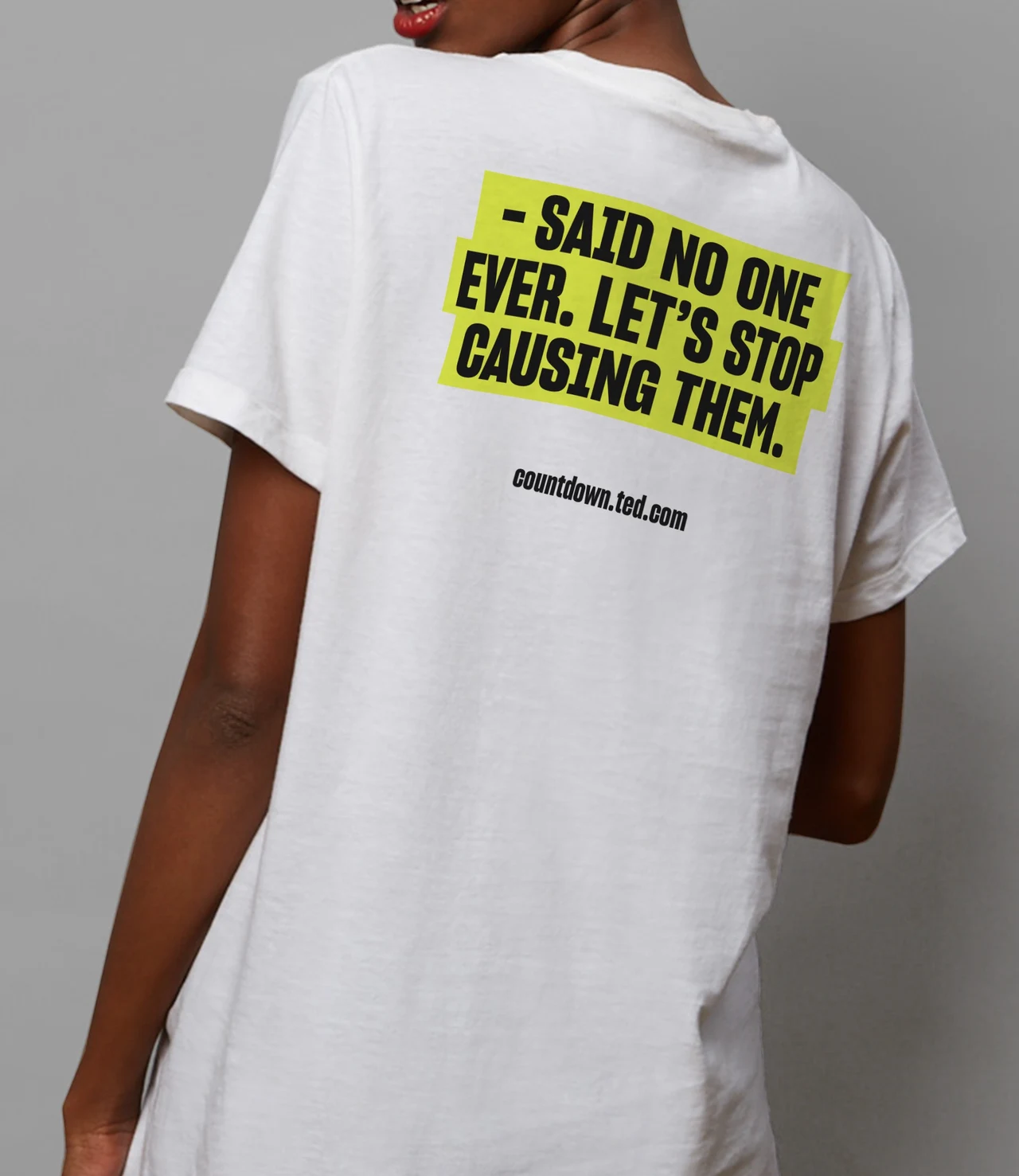 Back of a white T-shirt shows Said no one ever. Let’s stop causing them on a lime-yellow block, with the Countdown address underneath.