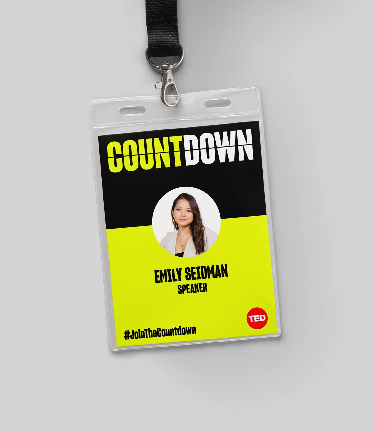Participant badge with a black lanyard combines the Countdown logo, a circular portrait, a speaker name and a lime-yellow field.
