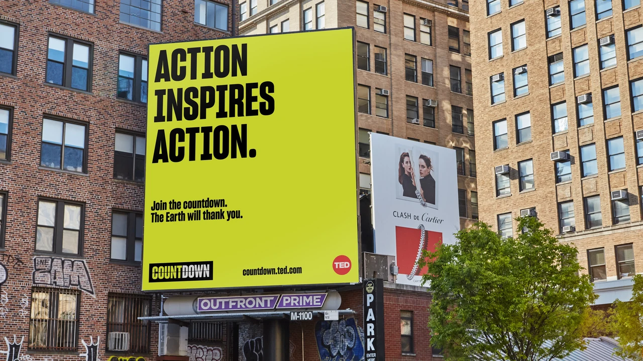 Lime-yellow billboard among brick buildings emphasizes Action inspires action, with smaller copy and Countdown and TED logos at the bottom.