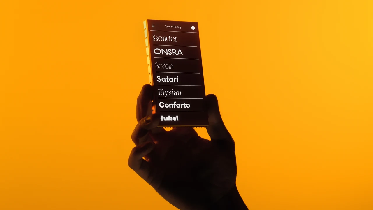 A silhouetted hand holds a smartphone against yellow; the dark screen presents a list of Type of Feeling type families in different styles.