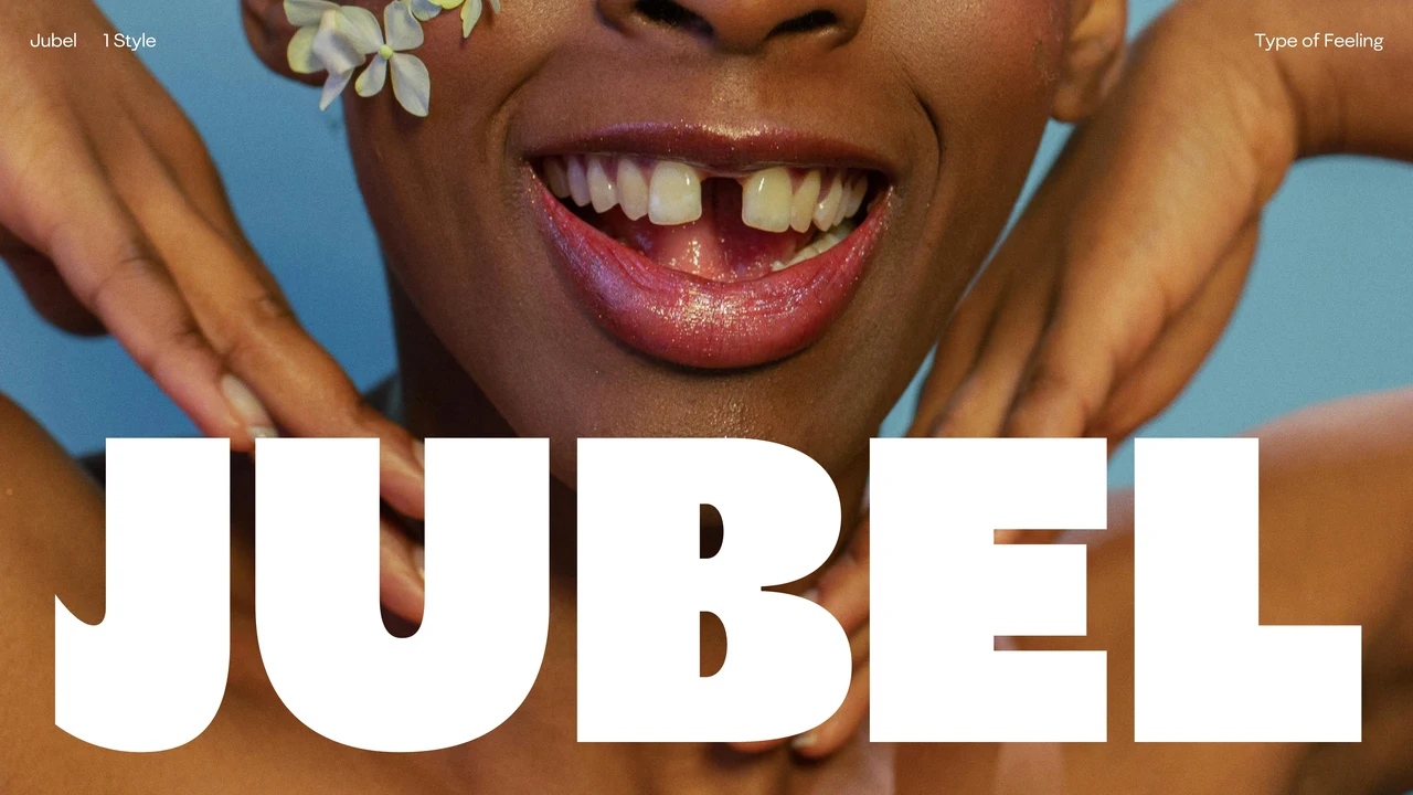 Jubel specimen features massive white lettering in front of a close-up of a smiling person, hands near the face, flowers and a blue background.