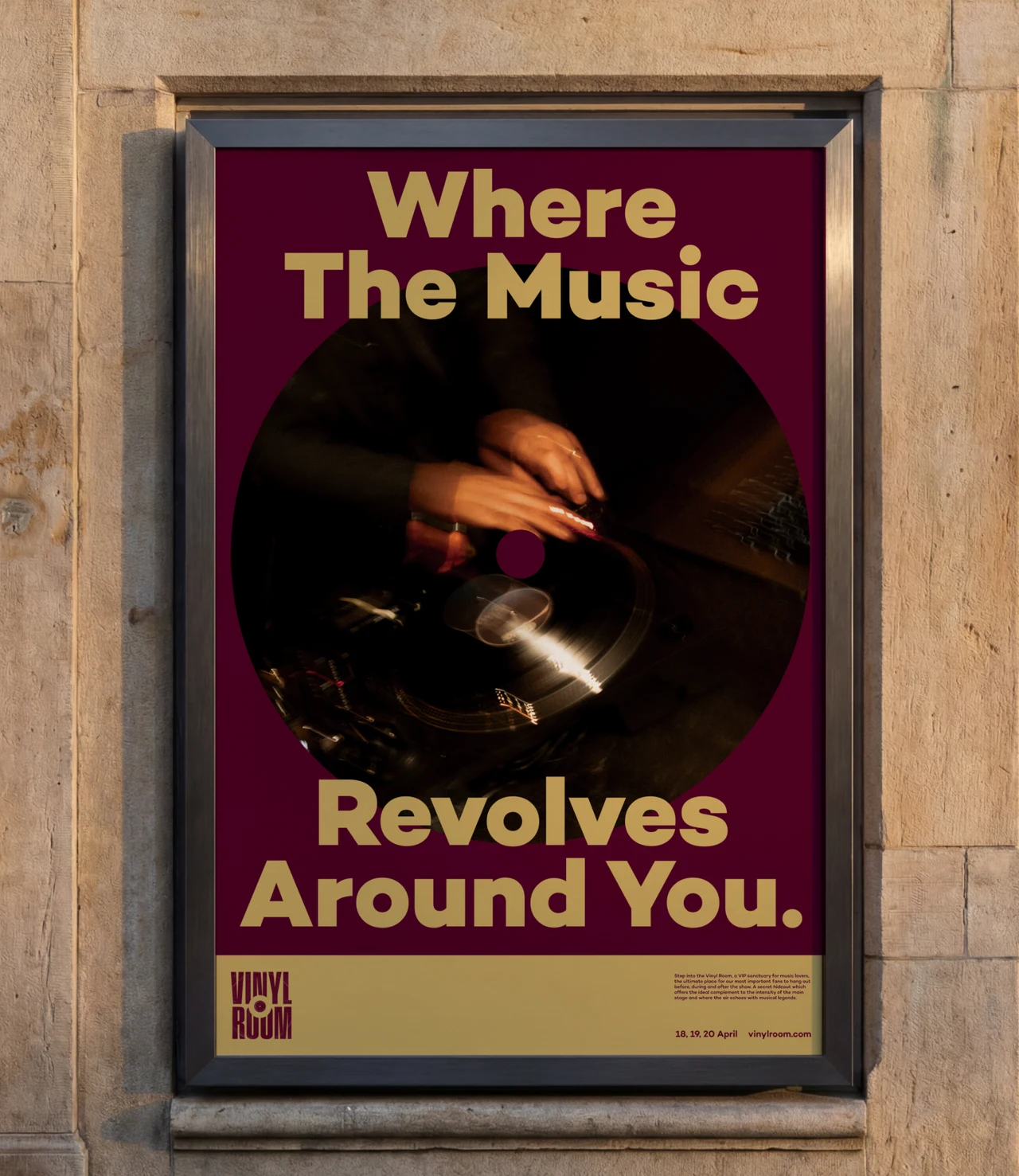 Framed burgundy poster on a stone wall reading Where the Music Revolves Around You in gold, around a photo of a DJ's hands on a turntable, with the Vinyl Room logo and dates.